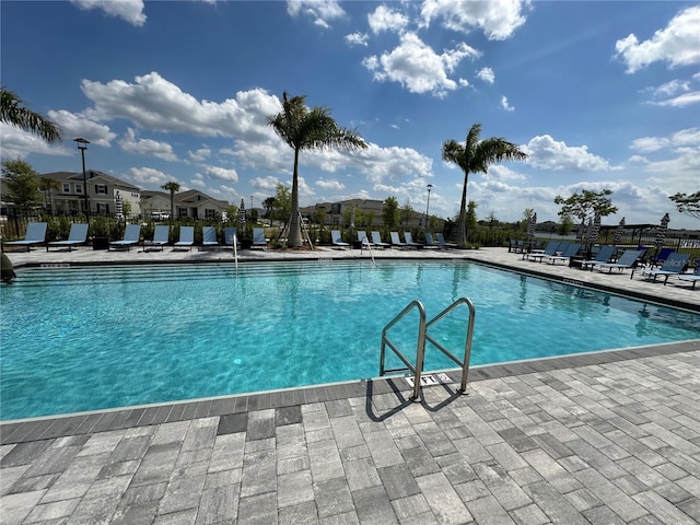 pool featuring fence and a patio