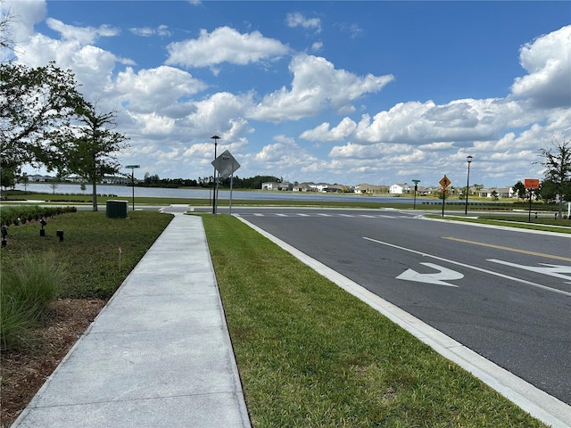 view of road with sidewalks and traffic signs