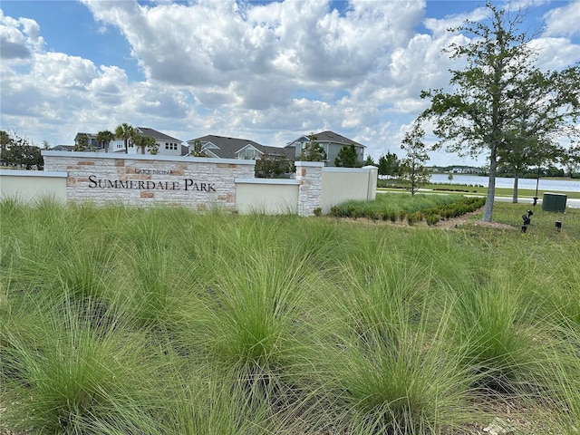 community / neighborhood sign featuring a water view