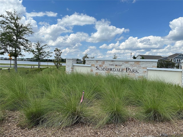 community / neighborhood sign featuring a water view