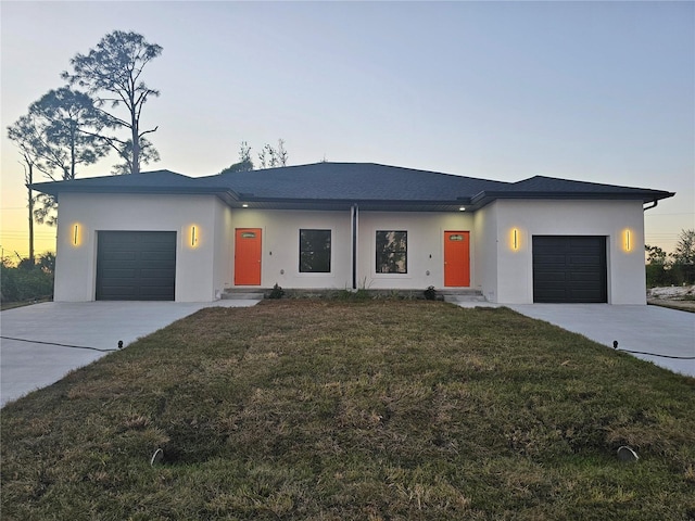 contemporary house featuring a garage and a yard