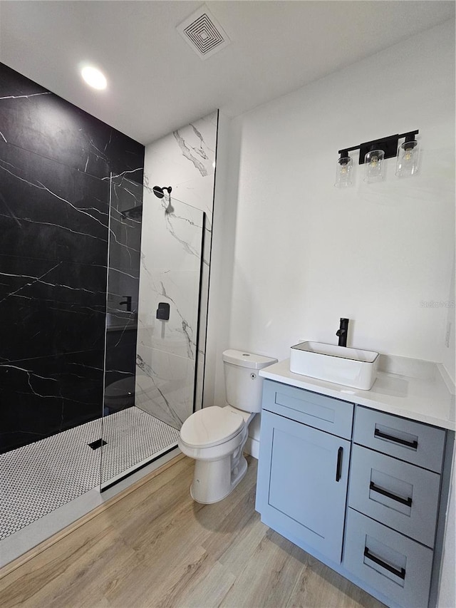8249 Dimstead St, Port Charlotte, FL 33981 - full bathroom with vanity, a marble finish shower, wood finished floors, and recessed lighting
