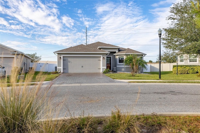 view of front of home with a garage and a front yard