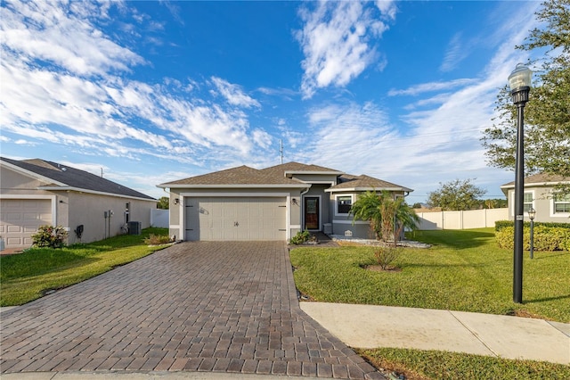 ranch-style home with cooling unit, a garage, and a front yard