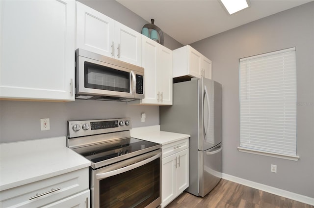 kitchen featuring white cabinets, appliances with stainless steel finishes, and dark wood-type flooring