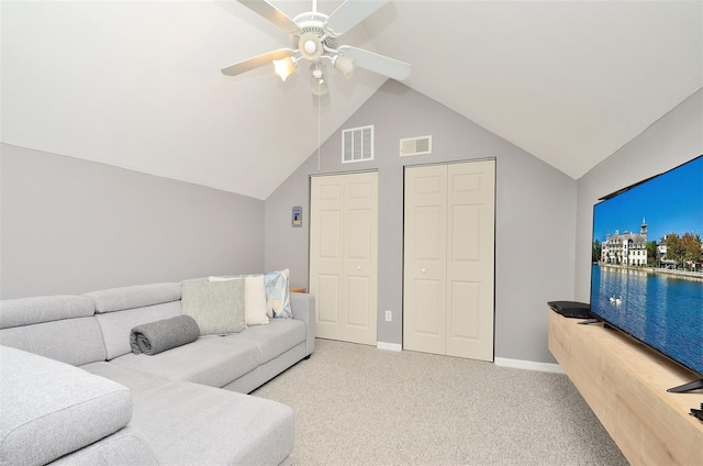 carpeted living room featuring ceiling fan and lofted ceiling