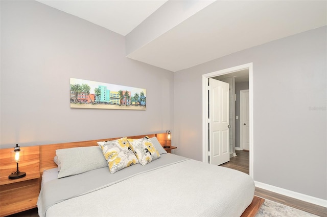 bedroom with dark hardwood / wood-style flooring