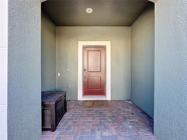 entrance to property with stucco siding