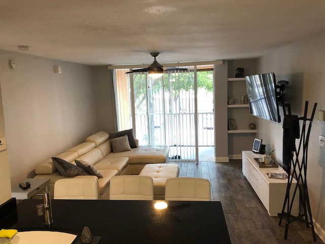 living room featuring ceiling fan and sink