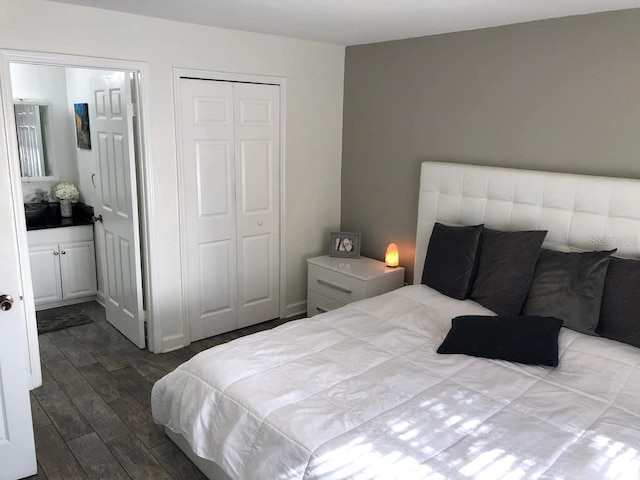 bedroom with connected bathroom, a closet, and dark wood-type flooring