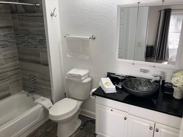 full bathroom with vanity, toilet, and tiled shower / bath