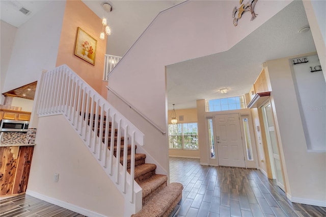 entryway featuring a notable chandelier and a high ceiling