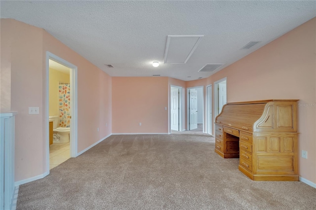 unfurnished living room with light colored carpet and a textured ceiling