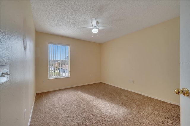 carpeted empty room featuring ceiling fan and a textured ceiling