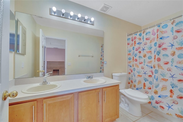 bathroom featuring a shower with curtain, tile patterned flooring, vanity, and toilet