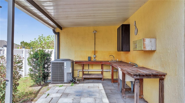 view of patio featuring central air condition unit and sink