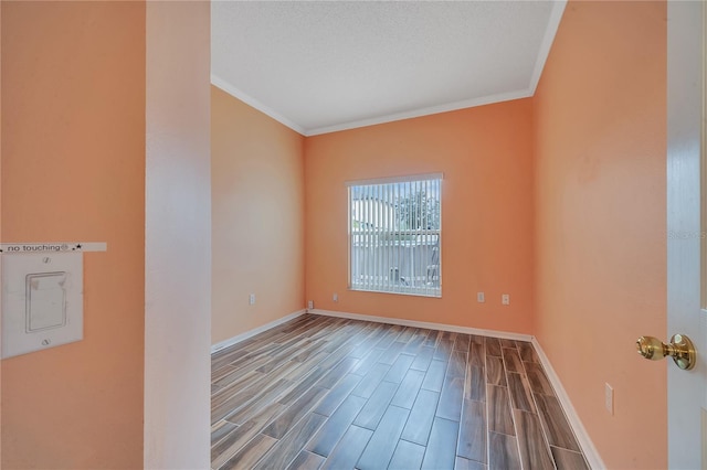 unfurnished room with a textured ceiling and crown molding