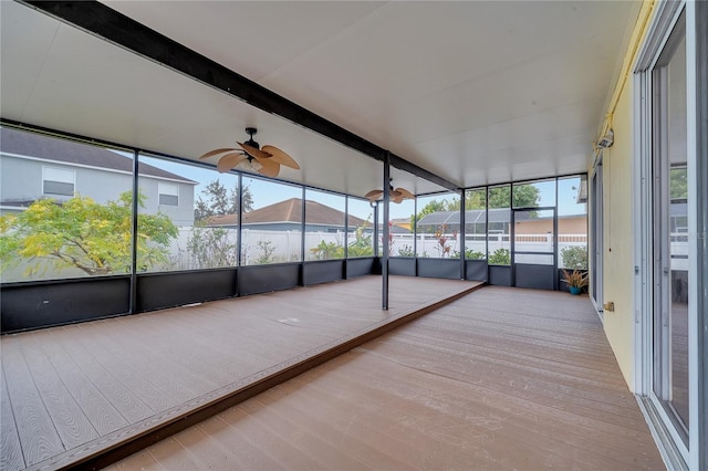 unfurnished sunroom with a wealth of natural light and ceiling fan