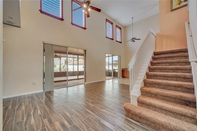 interior space featuring a high ceiling and ceiling fan