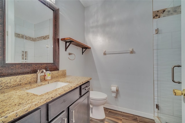 bathroom with vanity, toilet, and walk in shower