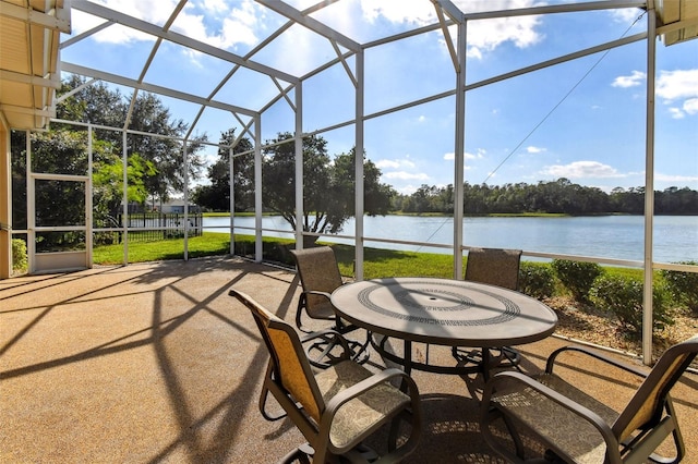 sunroom / solarium featuring a water view