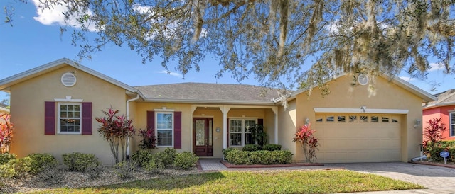 ranch-style home with a garage and a front lawn