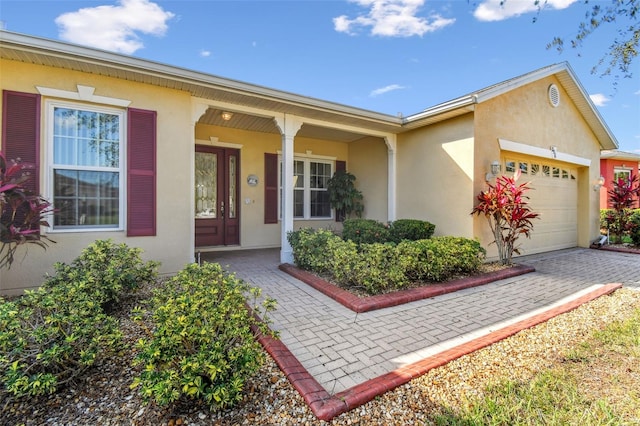 ranch-style home with covered porch and a garage