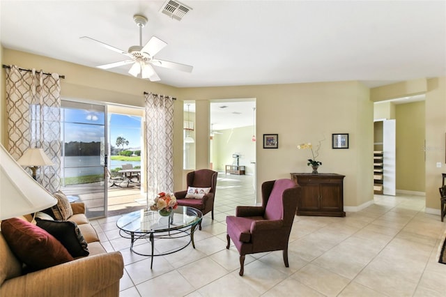 tiled living room featuring ceiling fan