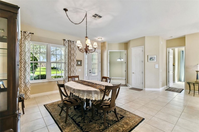 tiled dining space featuring a notable chandelier