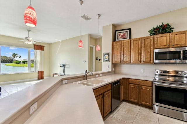 kitchen featuring ceiling fan, sink, decorative light fixtures, light tile patterned floors, and appliances with stainless steel finishes