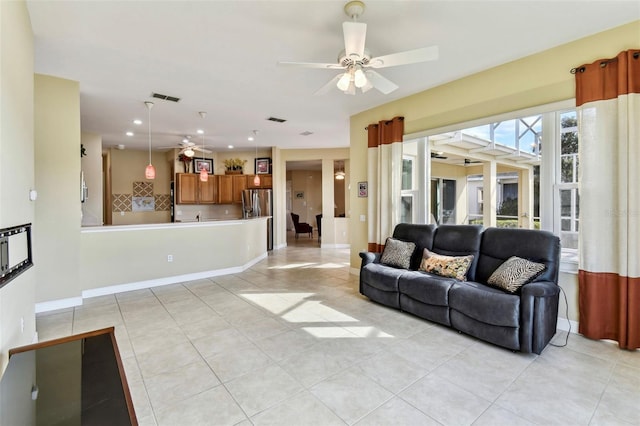 living room featuring ceiling fan and light tile patterned floors