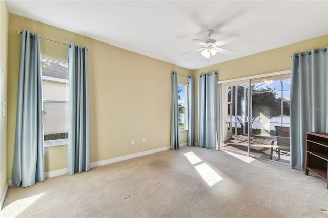 unfurnished room featuring ceiling fan and light carpet