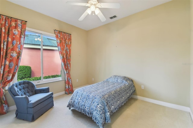 bedroom with ceiling fan and light carpet