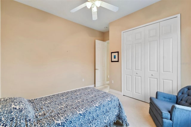 carpeted bedroom with ceiling fan and a closet