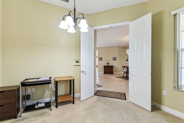 interior space featuring a notable chandelier and light colored carpet