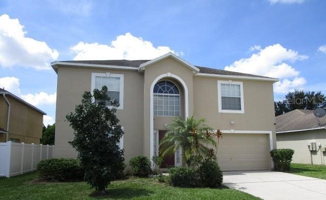 view of front of home featuring a front yard and a garage