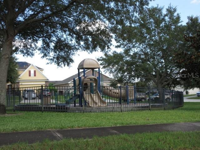 view of jungle gym featuring a lawn