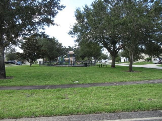 view of property's community with a lawn and a playground