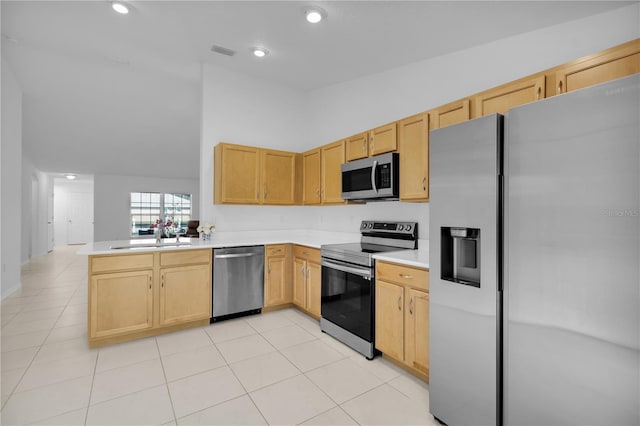 kitchen featuring kitchen peninsula, sink, light brown cabinets, and appliances with stainless steel finishes