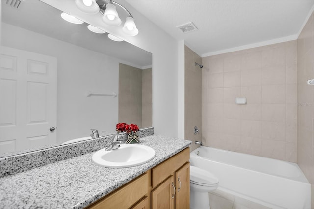 full bathroom featuring tile patterned flooring, vanity, toilet, and tiled shower / bath combo