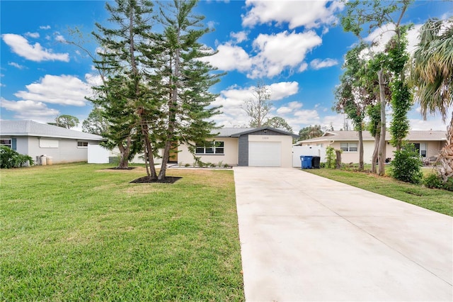 ranch-style home with a garage and a front lawn