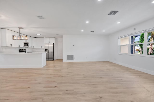 unfurnished living room with light hardwood / wood-style floors