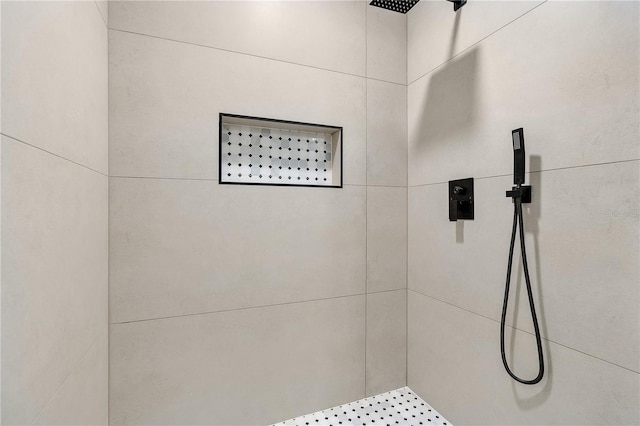 bathroom with a tile shower