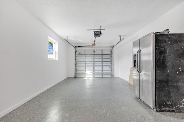 garage with stainless steel fridge with ice dispenser and a garage door opener