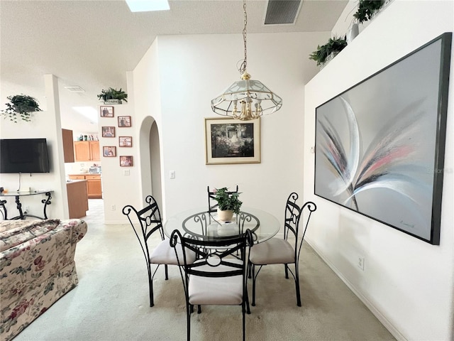 dining area with a chandelier and a textured ceiling