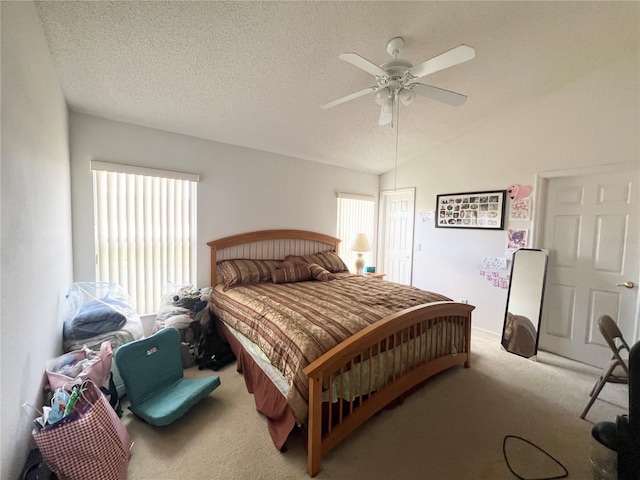 bedroom with carpet, ceiling fan, lofted ceiling, and a textured ceiling