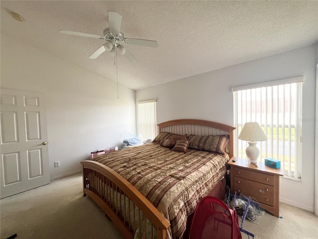 bedroom featuring ceiling fan, light carpet, and a textured ceiling