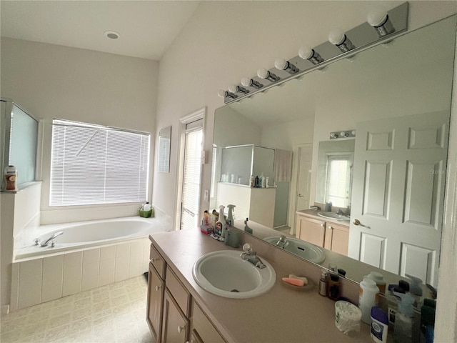 bathroom featuring plus walk in shower and vanity