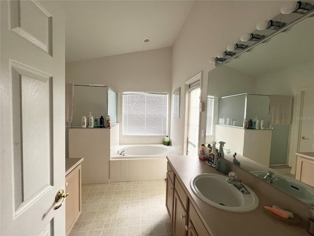 bathroom featuring vanity and shower with separate bathtub