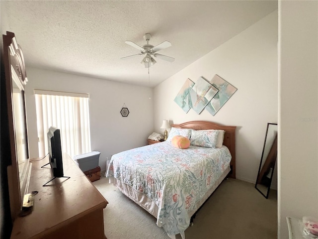 carpeted bedroom with a textured ceiling and ceiling fan